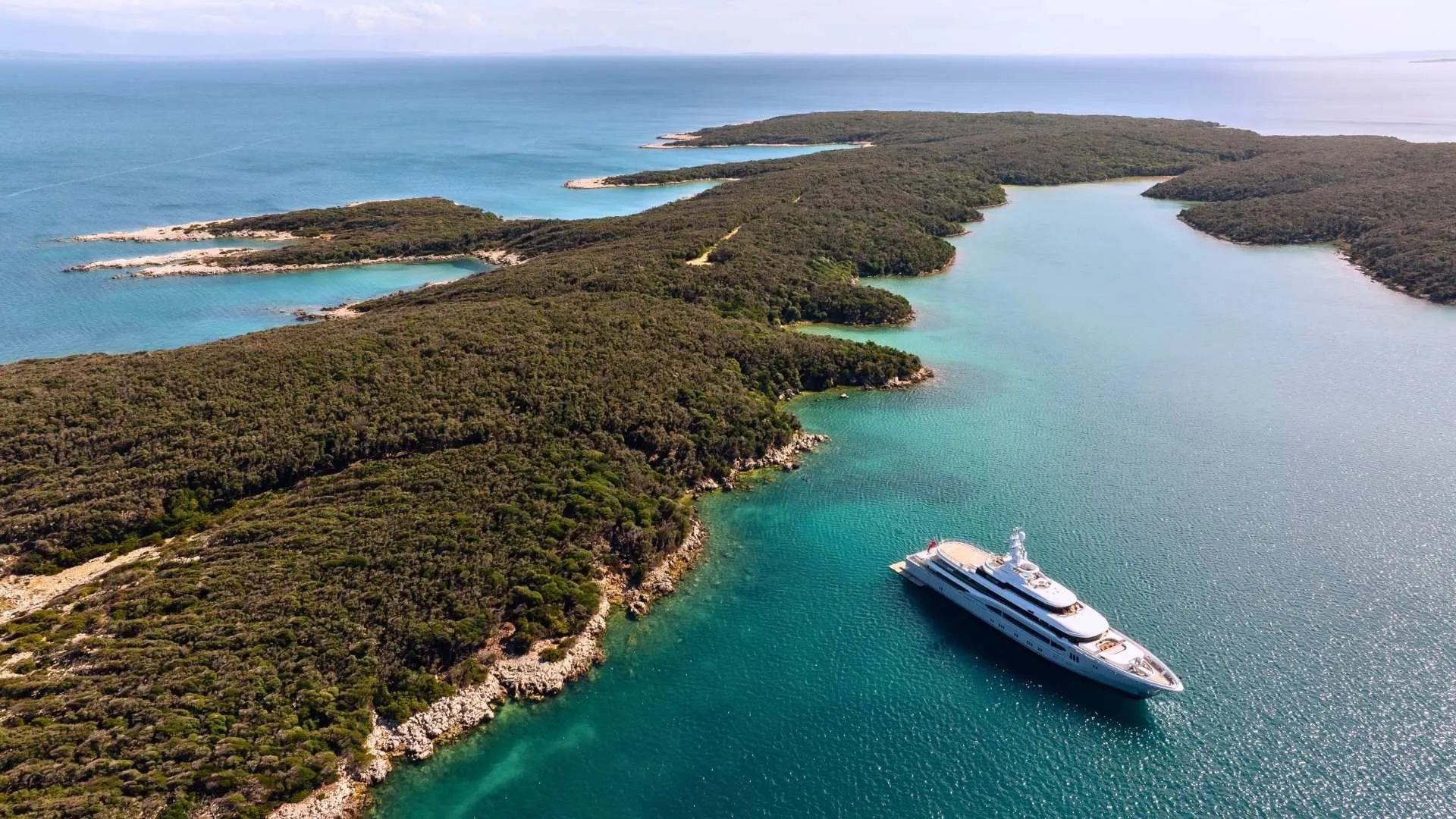 Yacht cruising past Croatia's island coastline